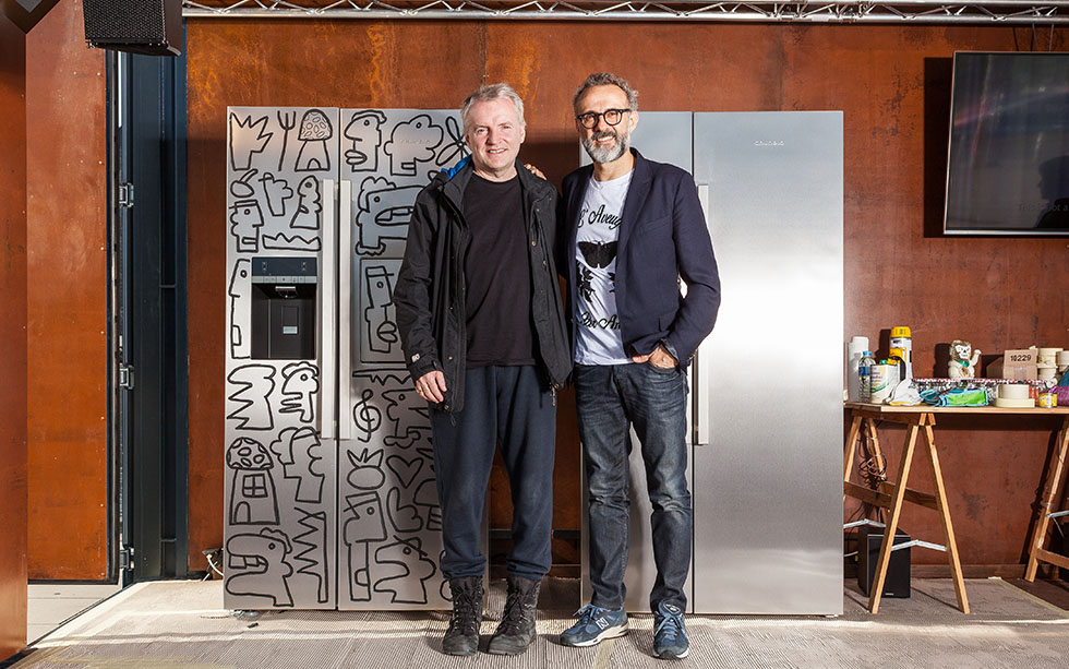 Thierry Noir and Massimo Bottura standing in front of a fridge.