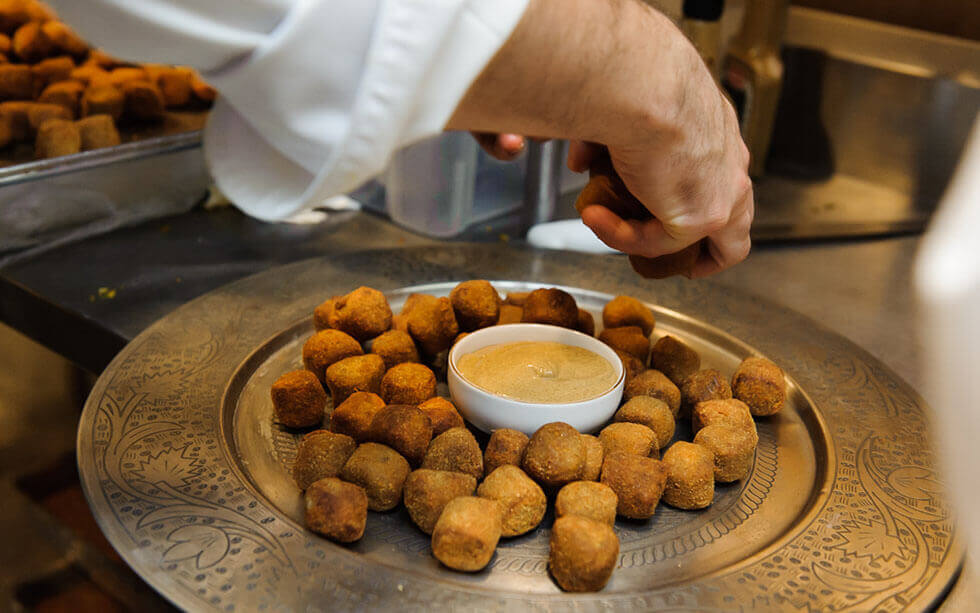 Hands cooking for Refettorio Gastromotiva